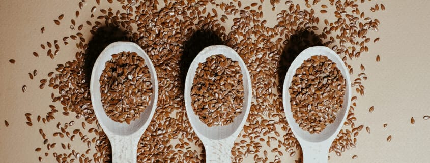 Three spoons full of flaxseed, an ingredient often included in horse diets