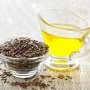 shutterstock_55762726 Seeds in a glass bowl and oil in another container, both sources of omega 3 fatty acids for horses