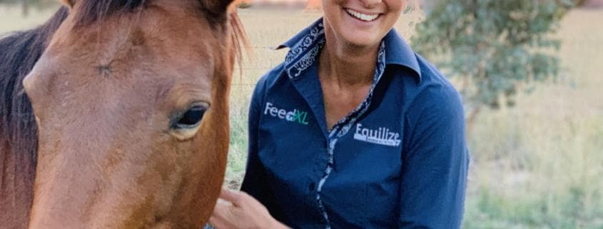 Photo of Nerida standing with her horse at sunset